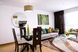 a living room with a couch and a glass table at Miraflores Nest Upper Pardo in Lima