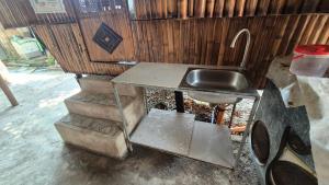 a kitchen with a sink and a pair of scissors at Rendan Kubo in Batangas City