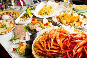 a table with many plates of food on it at Kobe Hotel Fruit Flower in Kobe