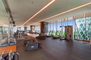 a gym with a lot of exercise equipment in a building at Discovery SCBD Jakarta in Jakarta