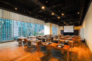 a large room with tables and chairs in it at Discovery SCBD Jakarta in Jakarta