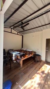 a bedroom with a large bed in a room at Luvyash Campsite Stays in Bhīm Tāl