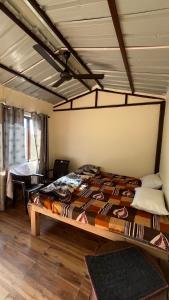 a bedroom with a large bed in a room at Luvyash Campsite Stays in Bhīm Tāl
