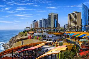 a view of a beach with buildings and the ocean at Miraflores Nest Upper Pardo in Lima