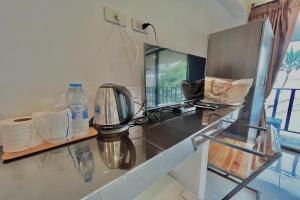 a kitchen with a counter top with a coffee maker at The Shore Samui in Bangrak Beach