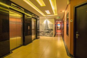 a hallway of a building with a hallwayngth at Citi M Hotel Gambir in Jakarta