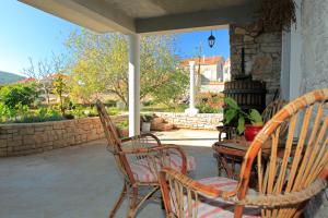 a patio with chairs and a table on a porch at Holiday Home Paric in Vela Luka