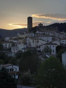 a group of white houses on a hill at sunset at Mood Valentina in Goriano Sicoli