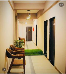 an empty hallway with a green floor in a building at Raj Hotel in Talala