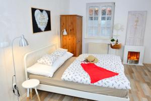 a bedroom with a bed and a fire place at Viktória Inn Tihany in Tihany