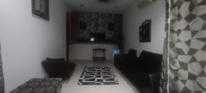 a living room with a checkered floor at Aisyhome in Jitra
