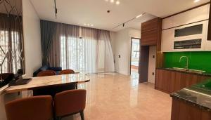 a kitchen with a counter and chairs in a room at Diamond Hotel Bỉm Sơn Thanh Hóa in Bỉm Sơn