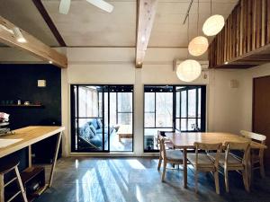a kitchen and dining room with a wooden table and chairs at Forest 99 in Nasushiobara +42 photos