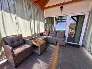 a screened in porch with two chairs and a table at ZitaLaka in Igal