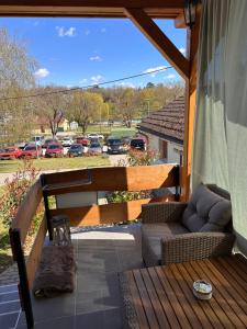 a porch with a couch and a patio with a parking lot at ZitaLaka in Igal