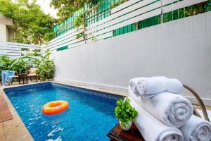 a pool with a frisbee and towels on a table at DanCenter Vana Villa I 5BHK I Pvt Pool I Baga I GOA in Goa