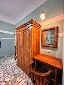 a room with a wooden cabinet and a mirror at Mangga Lodge in Bira