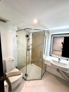 a bathroom with a shower and a toilet and a sink at Apartment Serenity Wongamat in North Pattaya +61 photos