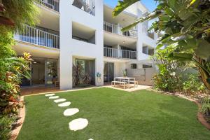 an apartment building with a lawn in front of it at Salad Days -Beachfront & Pet Friendly in Marcoola