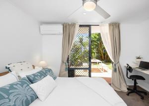 a bedroom with a bed and a desk and a window at Salad Days -Beachfront & Pet Friendly in Marcoola +25 photos