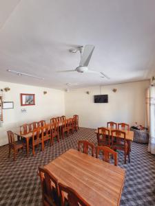 a conference room with wooden tables and chairs at Indus Motel in Skardu