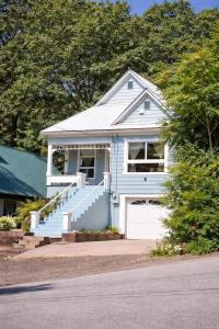 a blue house with stairs and a garage at Dunsmuir Getaway in Dunsmuir