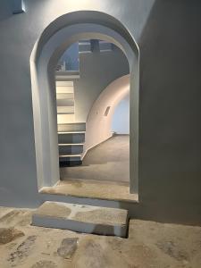 a hallway with an archway in a building at Aleminas Rooms 2 in Symi