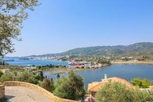 a view of a river with a town and mountains at Saint George Villas & Apartments in Skiathos