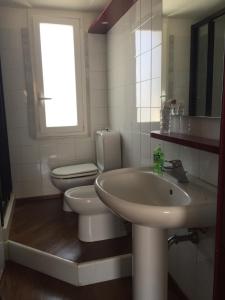 łazienka z umywalką, toaletą i oknem w obiekcie La casa di Teseo w mieście Cannizzaro