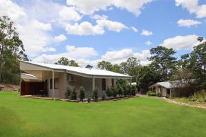 a house with a green lawn in front of it at Boonah Valley Motel in Boonah +10 photos