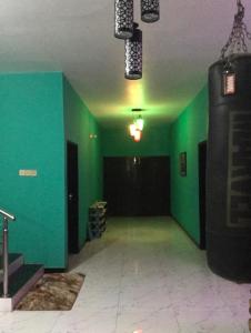 an empty room with green walls and a gym at Lucky villa in Sylhet