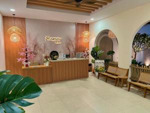 a lobby with a flower shop with a counter and benches at Numar Villas Yogyakarta in Seturan