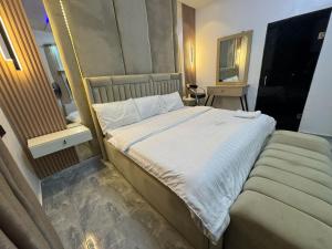 a large bed in a room with a mirror at Dejuks Hotel & Resort Executive Room in Mama