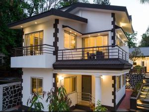 a large white house with a lot of windows at Esperanza Villas by SVAR Stays in Panchgani