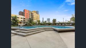 a swimming pool in a city with buildings at King Street Residences in Brisbane