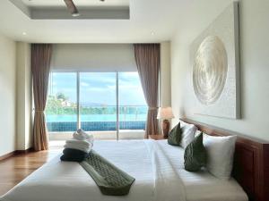 a bedroom with a large bed with a large window at Grand Kamala Falls in Kamala Beach +63 photos