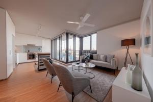 a living room with a couch and a table and chairs at King Street Residences in Brisbane