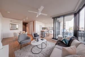 a living room with a couch and a table at King Street Residences in Brisbane