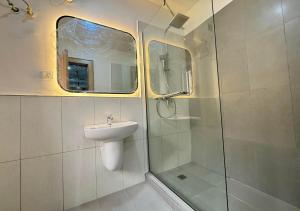 a bathroom with a shower and a sink and a shower at Fafje in Mama +11 photos