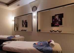 a hospital room with two beds and a mirror at Grand Tien Shan Hotel in Almaty