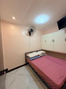 a room with a bed and a fan at serene genar in General Trias