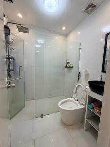 a bathroom with a toilet and a glass shower at serene genar in General Trias