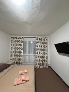 a bedroom with a bed with two pink pillows on it at Garage in Yaremche +43 photos