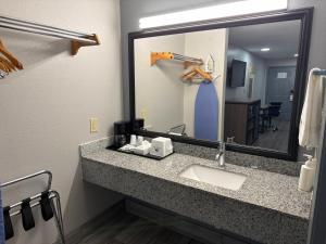 a bathroom with a sink and a mirror at Americas Best Value Inn Cabot in Cabot +10 photos