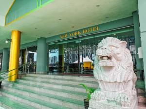 a statue of a lion in front of a new work hospital at New York Hotel in Johor Bahru