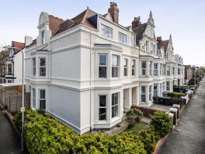 a large white building on the side of a street at Clarence House in Llandudno