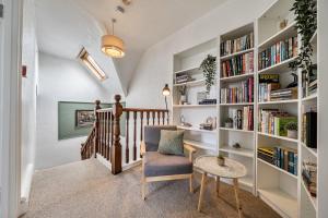 a room with a staircase with bookshelves at Clarence House in Llandudno