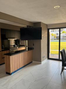 a kitchen with a counter top with a large window at Xochitepec Residencial in Atlacholoaya