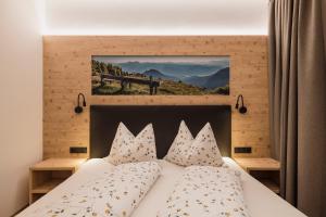 a bedroom with a bed with a picture on the wall at Chalet Schaller in Missiano +94 photos
