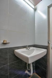 a white sink in a bathroom with a mirror at Da Down Resort & Hotel in Candolim